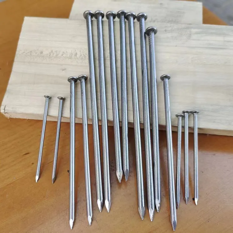 Metal construction nails arranged on a wooden surface